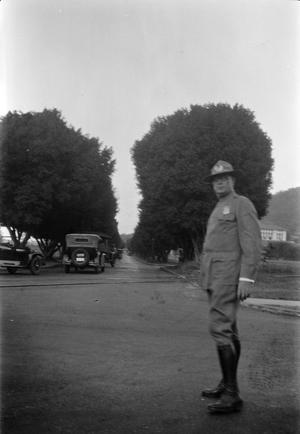 Primary view of object titled '[Police Officer Standing in a Street]'.