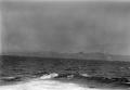 Photograph: [Rough Sea in Front of Land Mass]