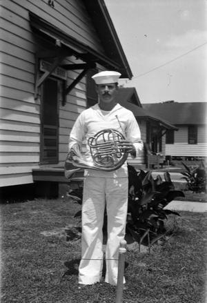[J. Opre McCoy Holding a French Horn]