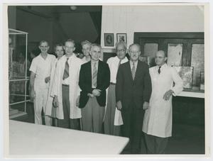 Primary view of object titled '[Dr. Chauncey D. Leake and Seven Colleagues at a Medical Exhibition]'.