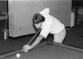 Photograph: [Tim Bell plays pool in Moler Hall game room.]