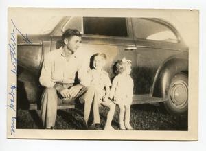 Primary view of object titled '[Aubrey Loving, Aron Alexander, and Martha Scott Sitting on a Car Door Sill]'.