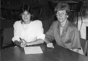Primary view of object titled '[Paula Robinson, left, receives a scholarship award for business from Bobbie Myers.]'.