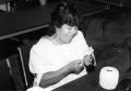 Photograph: [Mary Padilla crochets during continuing education class.]