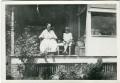 Photograph: [Family Seated in front of Home]
