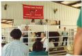 Primary view of [People Standing Around a Bull in a Ring at Dispersal Sale]