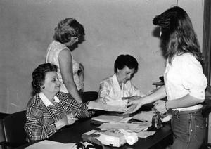 [Billie Malloy, left, and Opal Mitchamore help students during registration.]