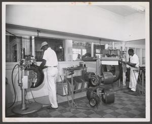 Primary view of object titled '[Two Men Working at Johnnie Johnson Tire Co.]'.
