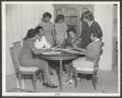 Photograph: [Women Around Dining Room Table]