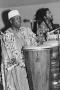Photograph: [Babatunde Olatunji Playing a Drum and Singing]