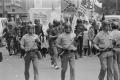 Photograph: [Police Officers Walking In Front of KKK Members During Rally]