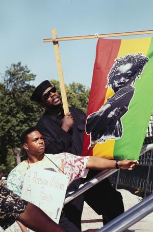 [Two Men With Flag at Texas Education Agency African American Protest]