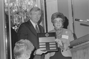 Primary view of object titled '[Governor Mark White and Woman Holding a Plaque]'.