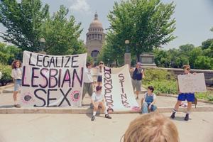 [Front View of Lesbian Avengers Members Holding Signs at Texas Capitol]