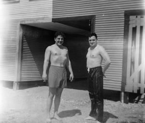 [Two Shirtless Men Outside of Building]