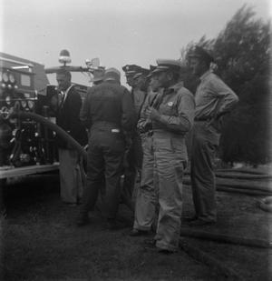 Primary view of object titled '[Several Firefighters Next to Fire Engine]'.