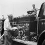 Photograph: [Man with Clipboard By Fire Engine]