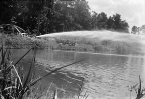 [Water Spraying Over Pond]