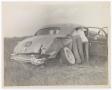Photograph: [Three People Leaning Into Damaged Car]