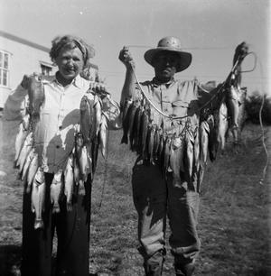 [Two People Holding Strings of Fish]
