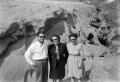 Photograph: [Three People in Front of Rock Formation]