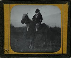 Primary view of object titled 'Glass Slide of Arab on Horseback'.