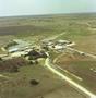 Thumbnail image of item number 1 in: 'Aerial Photograph of Livestock Auction Barn (Callahan County, Texas)'.