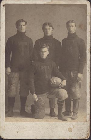[Four University of Texas at Austin football players in uniform with 1898 ball]