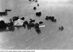 [Partially Submerged House in Floodwaters]