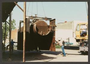 Primary view of object titled '[Construction Workers Guiding Crane Moving Heavy Machinery]'.