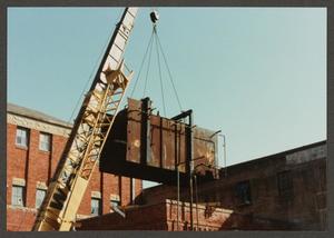 Primary view of object titled '[Crane Removing Heavy Machinery from Dr. Pepper Museum]'.