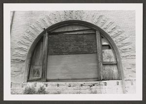 [Arched Window Boarded Up]