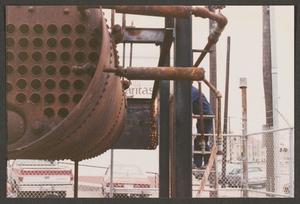[Photograph of Worker Using Breaking Down Heavy Machinery]