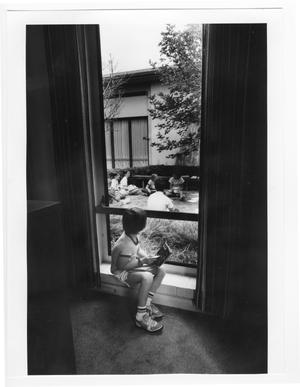 Unidentified Boy Looking Out Window at the Denton Public Library