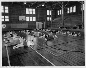 [Women's gym class stretching at Austin Athletic Center]