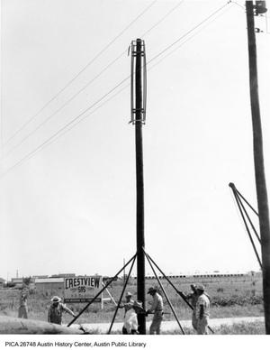 [Men erecting telephone or power pole in Crestview neighborhood]