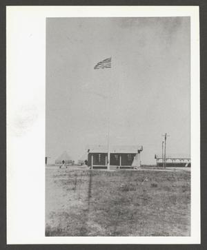 Primary view of object titled '[Cabin With U.S. Flag]'.