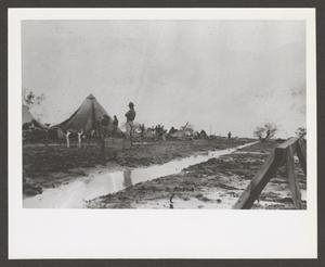 [Soldiers in a Muddy Camp Area]