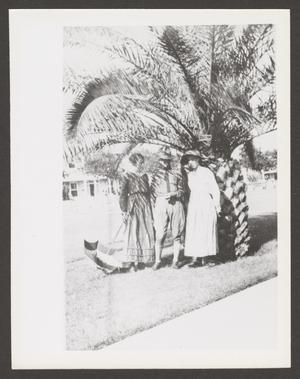 [Soldier and Two Women Under Tree]