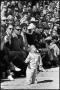 Photograph: [Small Child Stands in Front of Spectators at Sheppard AFB 25th Anniv…
