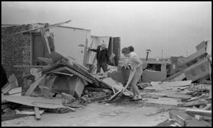 [People Looking Through Rubble After Tornado]