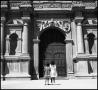 Photograph: [Children Stand Before Ornate Cathedral Door]