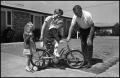 Photograph: [Family Helps Girl Ride Bike]