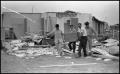Photograph: [Men Recover Items From Destroyed Home]