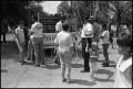 Photograph: [Handing Out Fishing Rods at Kids Fishing Rodeo]