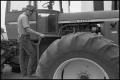 Photograph: [Man Stands on Tractor]