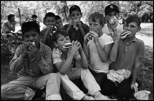 Primary view of object titled '[Boys Eating Hot Dogs at Kid Fishing Rodeo]'.