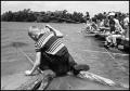 Photograph: [Boy on Log Fishes Next to Pier]