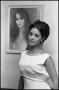 Photograph: [Mrs. Robert Wagner Poses Next to Female Painting]