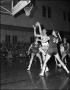 Photograph: [M.U. Indians Mid-Jump for Basket]